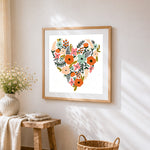 Floral heart illustration cross stitch artwork displayed on wall as home decor