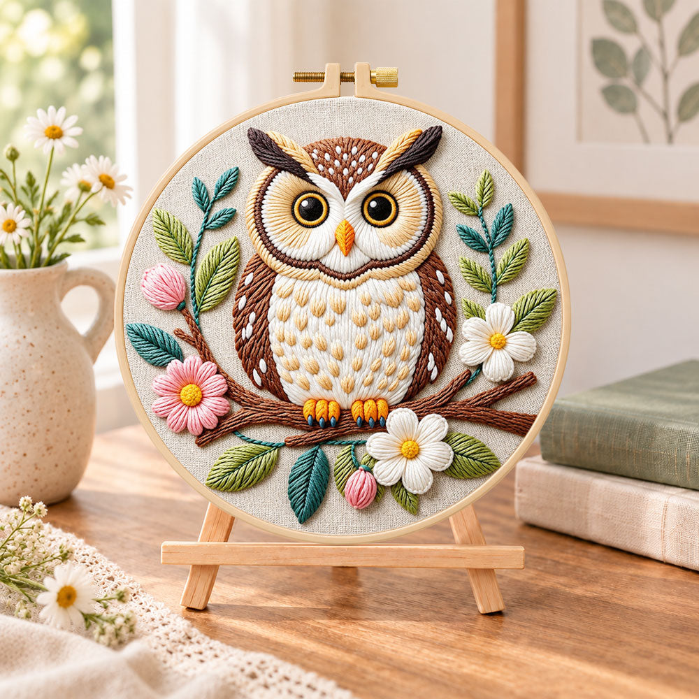 Floral owl on branch embroidery kit finished hoop displayed on a wooden stand as cosy tabletop decor