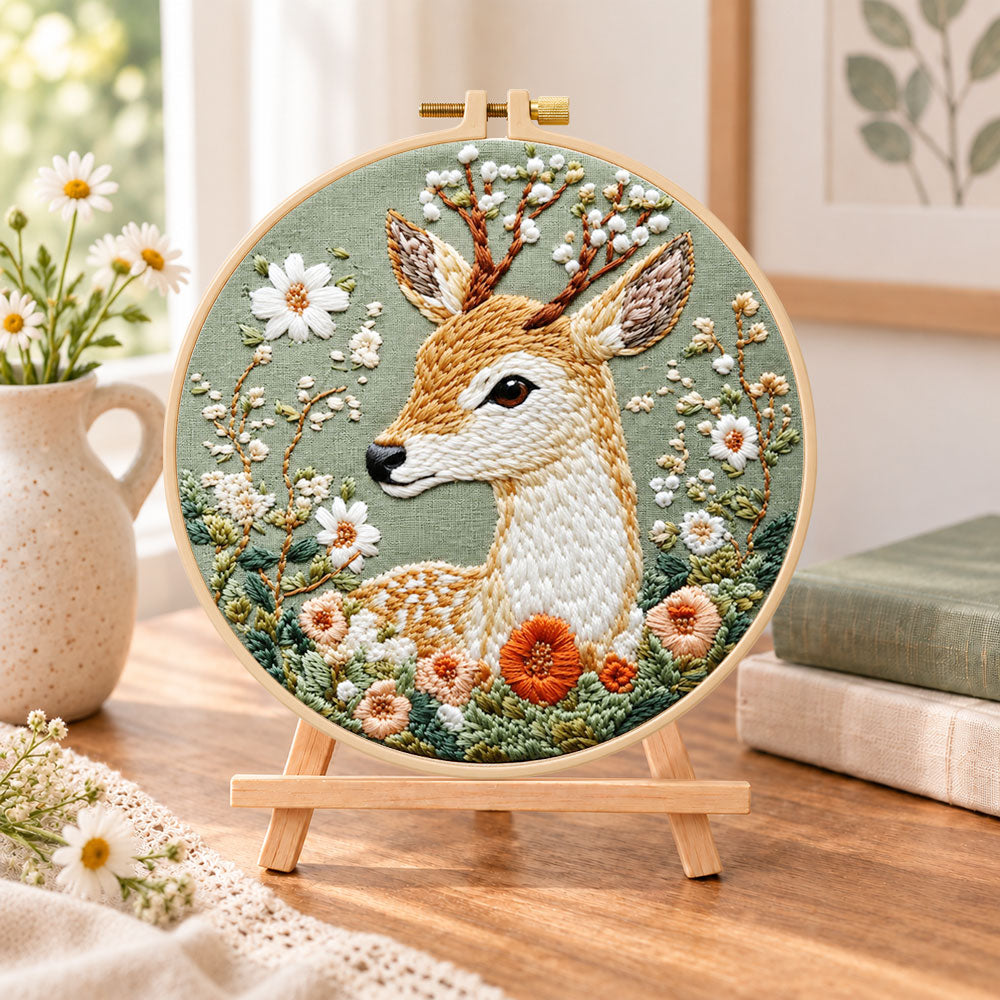 Floral sika deer embroidery kit finished hoop displayed on a wooden stand as cosy tabletop decor