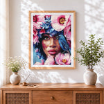 Finished floral woman with bluebird cross stitch artwork displayed