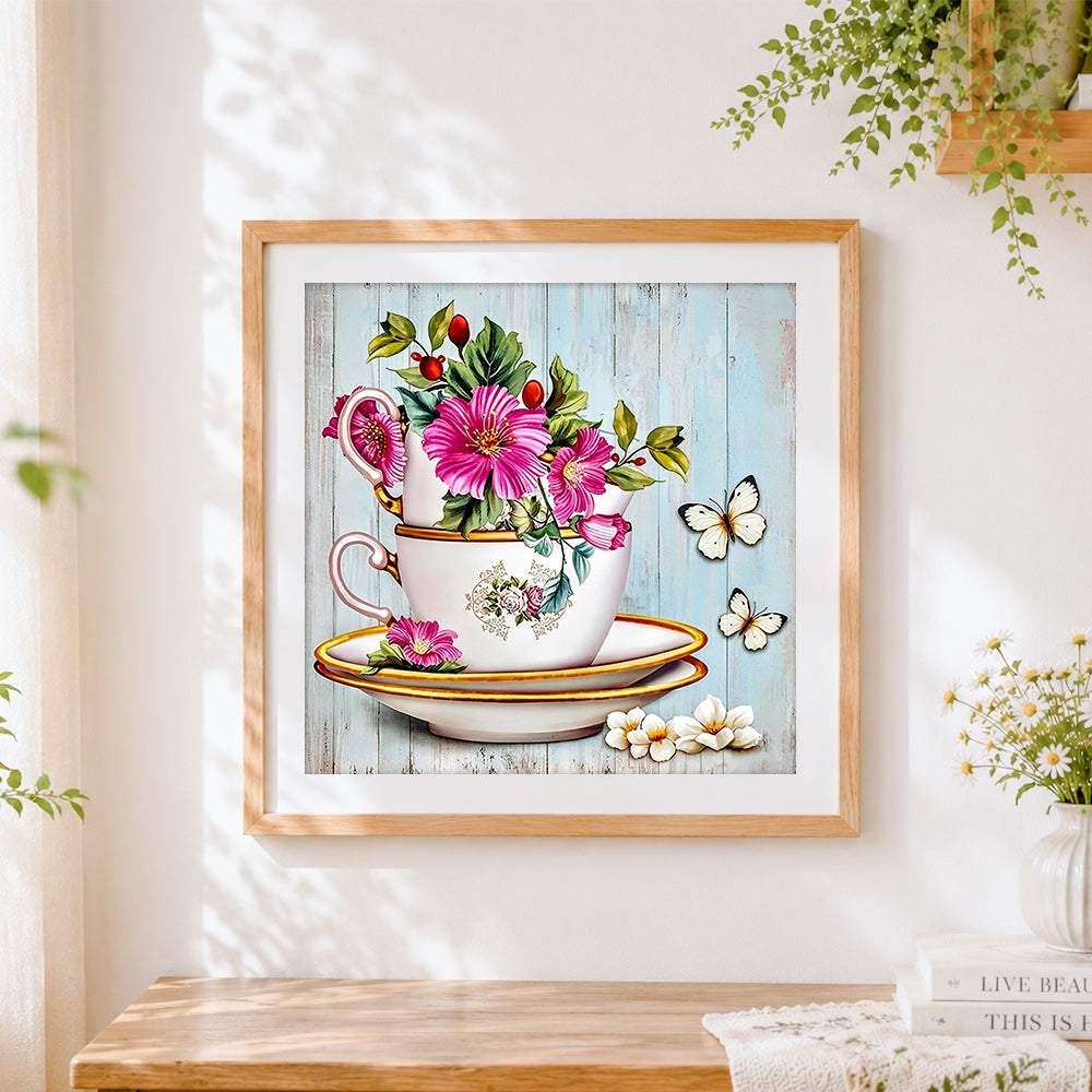Finished flowers in a vintage teacup with butterflies cross stitch artwork displayed