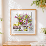 Finished flowers in a white jug with apples cross stitch artwork displayed