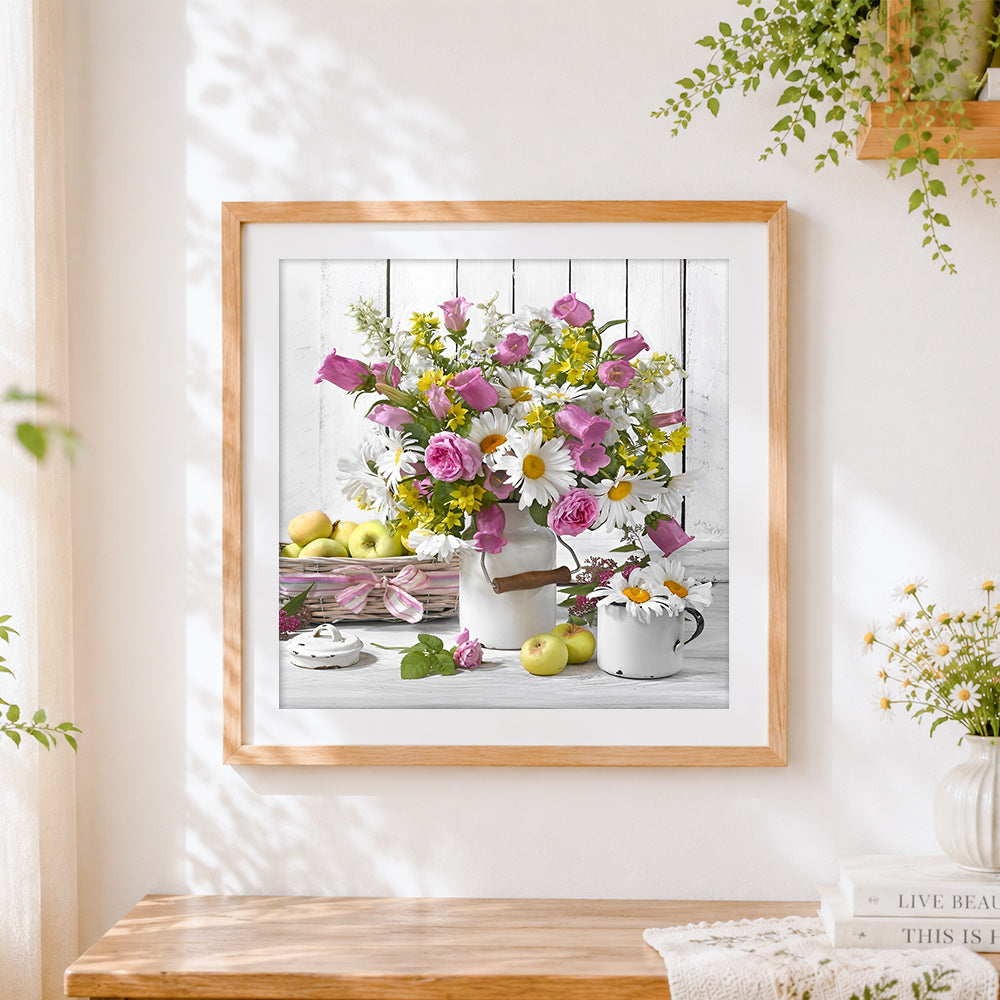 Finished flowers in a white jug with apples cross stitch artwork displayed