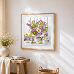Flowers in a white jug with apples cross stitch artwork displayed on wall as home decor