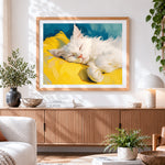 Finished fluffy white cat sleeping on a yellow pillow cross stitch artwork displayed