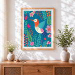 Finished folk art hummingbird and floral pattern cross stitch artwork displayed
