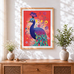 Finished folk art peacock on red background cross stitch artwork displayed