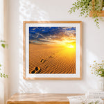 Finished footprints in desert sand at sunrise cross stitch artwork displayed