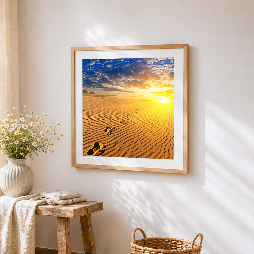 Footprints in desert sand at sunrise cross stitch artwork displayed on wall as home decor