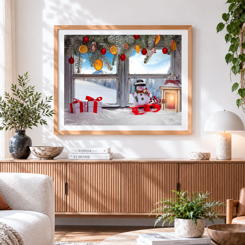 Finished frosty window sill with snowman and gifts cross stitch artwork displayed