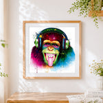 Finished funky chimpanzee with tongue out cross stitch artwork displayed