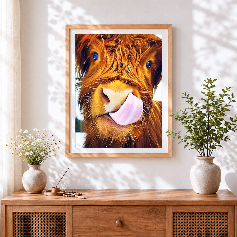 Finished funny highland cow licking lips cross stitch artwork displayed