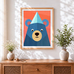 Finished geometric blue bear with party hat cross stitch artwork displayed