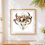 Finished geometric floral deer skull cross stitch artwork displayed