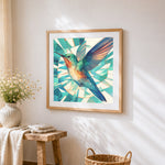 Geometric hummingbird in flight cross stitch artwork displayed on wall as home decor
