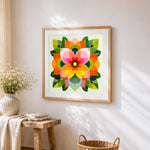 Geometric petals and leaves cross stitch artwork displayed on wall as home decor