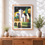 Finished geometric village with moon cross stitch artwork displayed