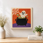 Finished ghost in cauldron artwork displayed on a wall