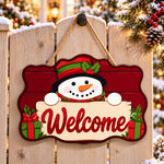 Gift box snowman paint by numbers door hanger on a garden gate