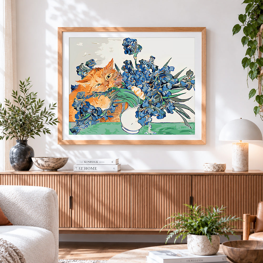 Finished ginger cat and blue irises cross stitch artwork displayed