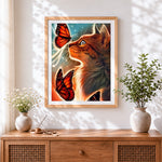Finished ginger cat and orange butterflies cross stitch artwork displayed