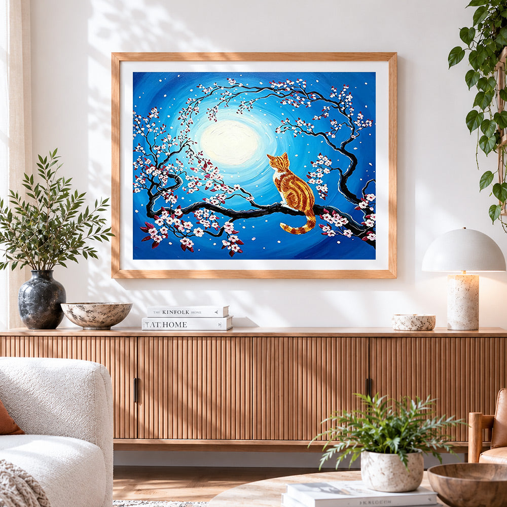 Finished ginger cat in a cherry blossom tree cross stitch artwork displayed
