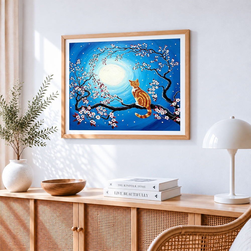 Ginger cat in a cherry blossom tree cross stitch artwork displayed on wall as home decor