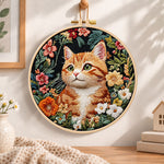 Ginger cat in wild blooms embroidery hoop wall art displayed as warm and cozy handmade home decor