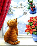 Ginger cat looking at a snowy church cross stitch kit for beginners