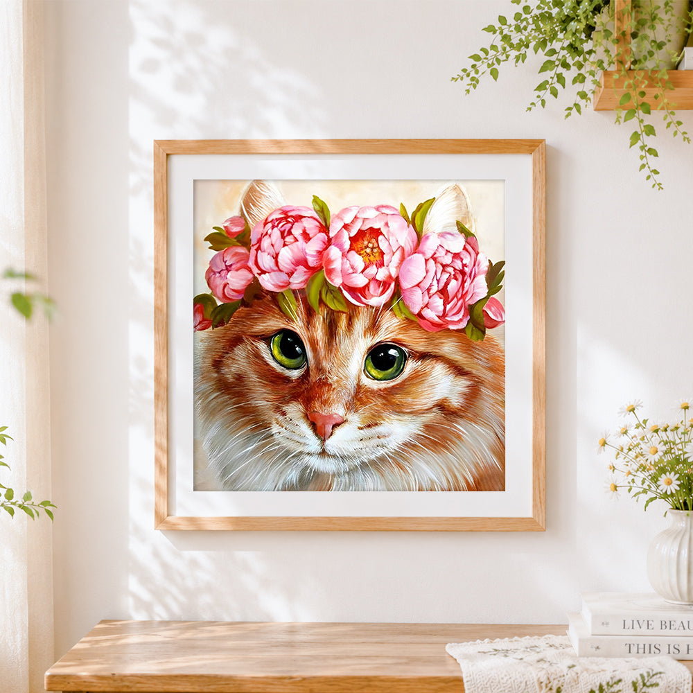 Finished ginger cat with pink peony crown cross stitch artwork displayed