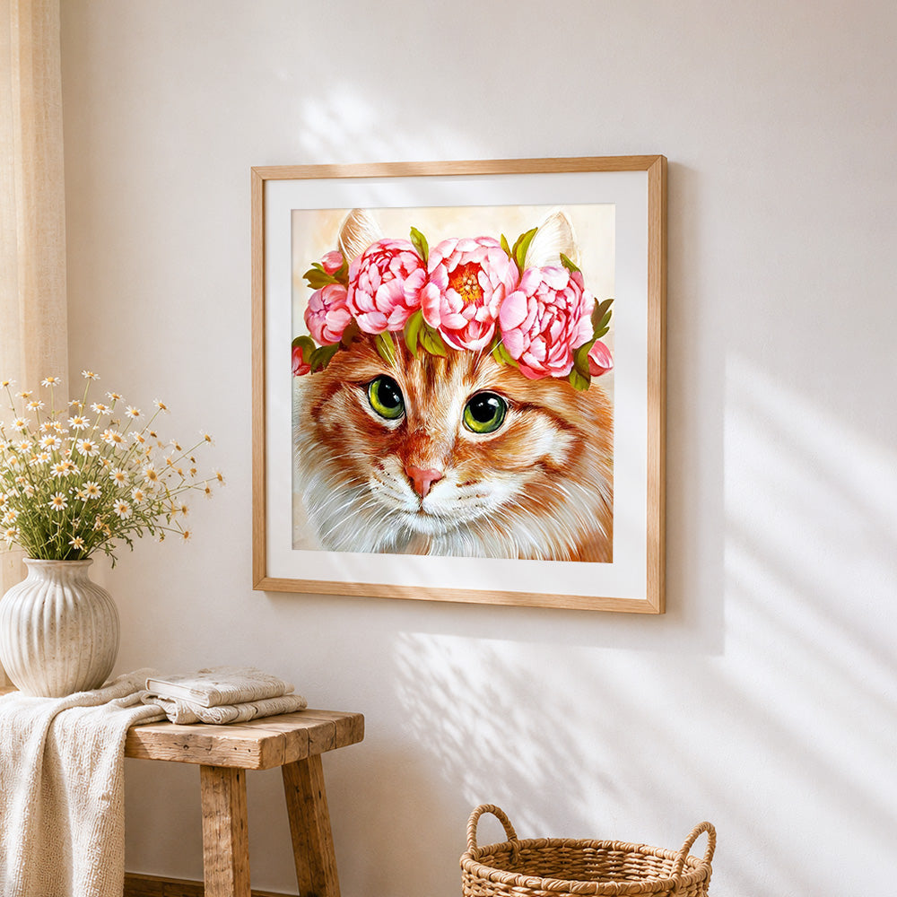 Ginger cat with pink peony crown cross stitch artwork displayed on wall as home decor