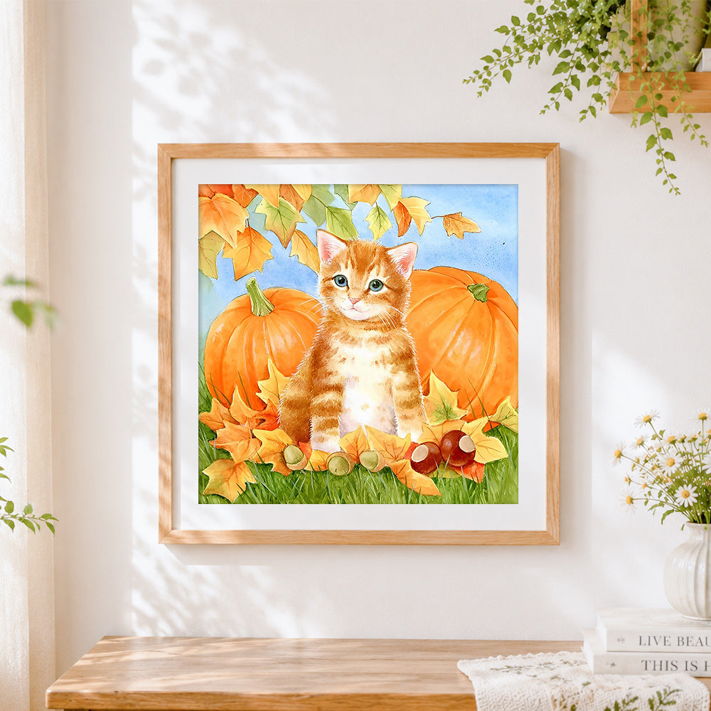 Finished ginger kitten with autumn pumpkins cross stitch artwork displayed