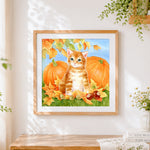 Finished ginger kitten with autumn pumpkins cross stitch artwork displayed