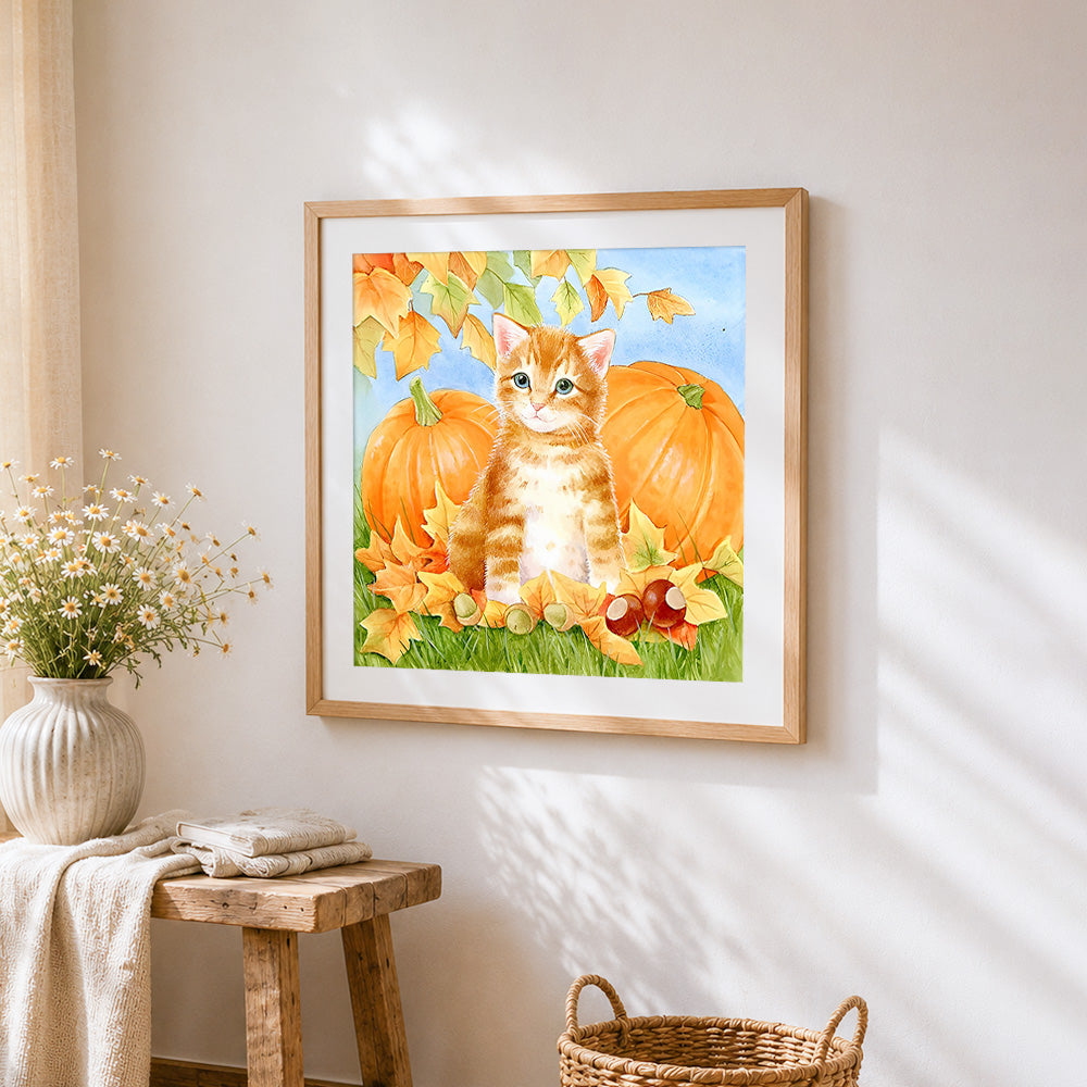 Ginger kitten with autumn pumpkins cross stitch artwork displayed on wall as home decor