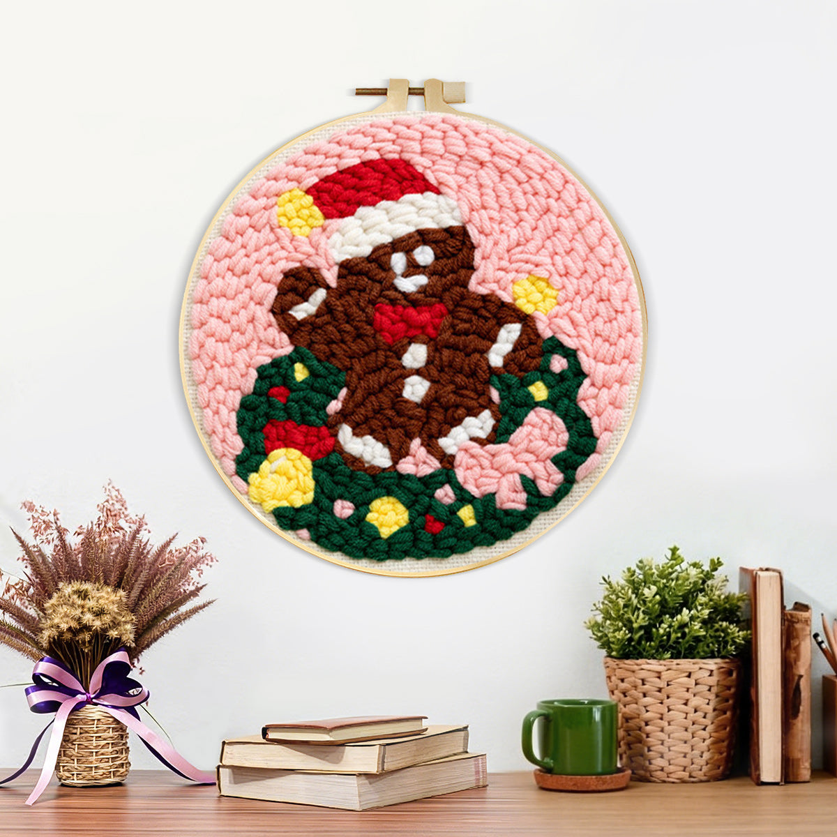 Finished gingerbread man in wreath artwork displayed on a wall