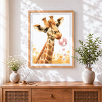 Finished giraffe blowing bubbles cross stitch artwork displayed