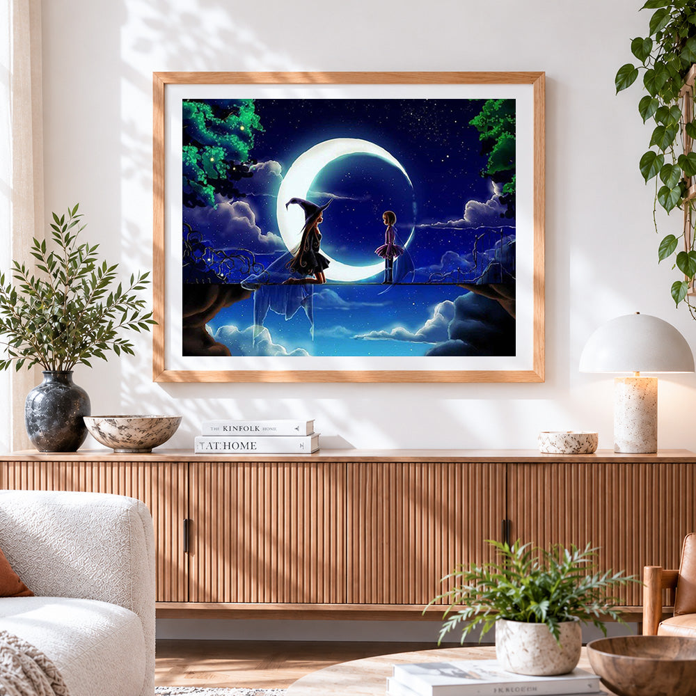 Finished girl and witch on a crescent moon cross stitch artwork displayed
