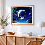 Girl and witch on a crescent moon cross stitch artwork displayed on wall as home decor