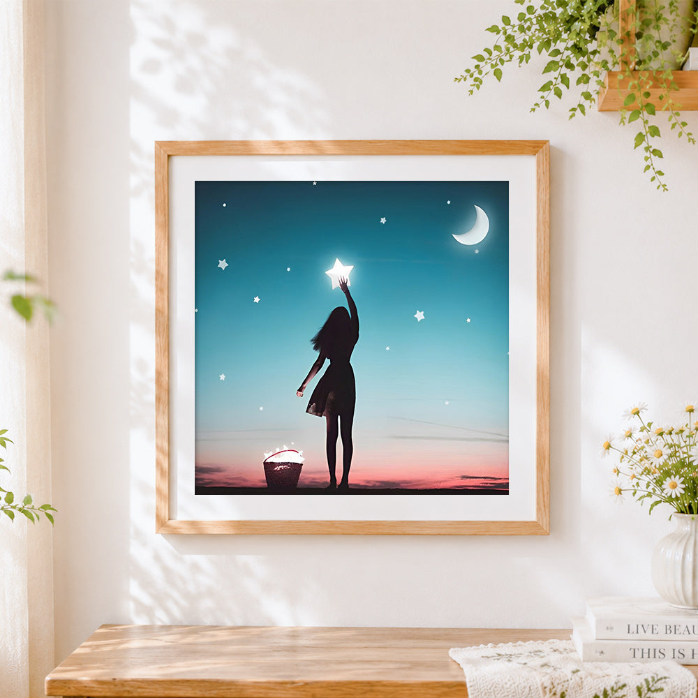 Finished girl catching stars cross stitch artwork displayed
