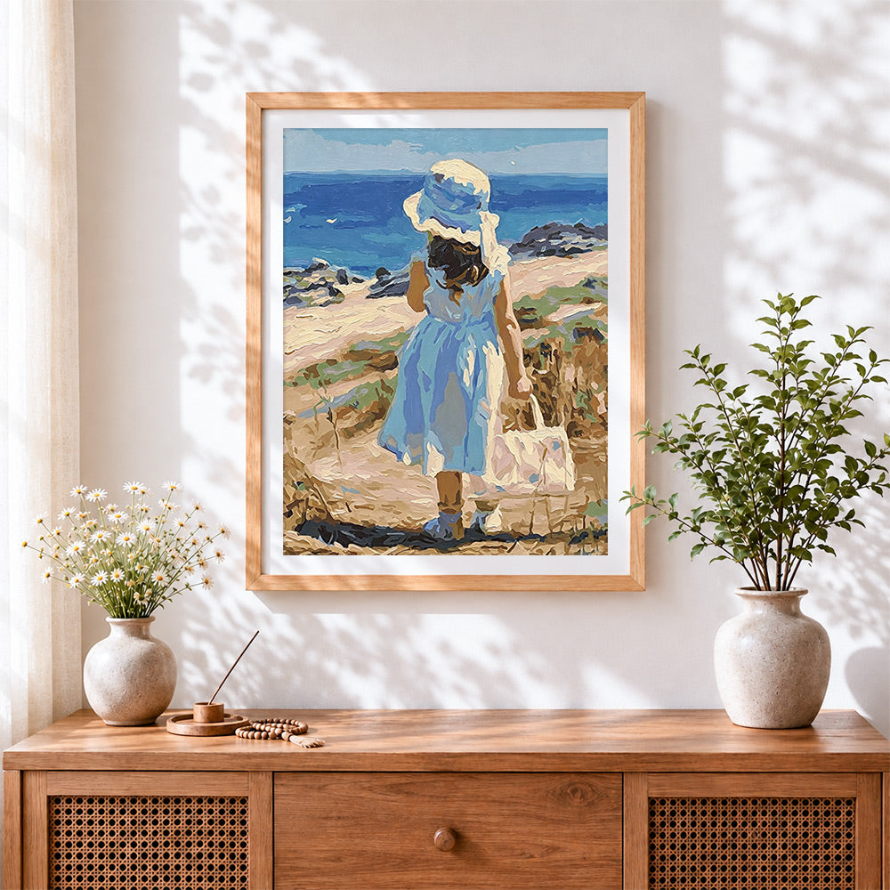 Finished girl in blue dress by the sea cross stitch artwork displayed