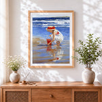 Finished girl on beach with red bucket cross stitch artwork displayed