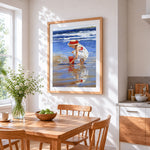 Girl on beach with red bucket cross stitch artwork displayed on wall as home decor