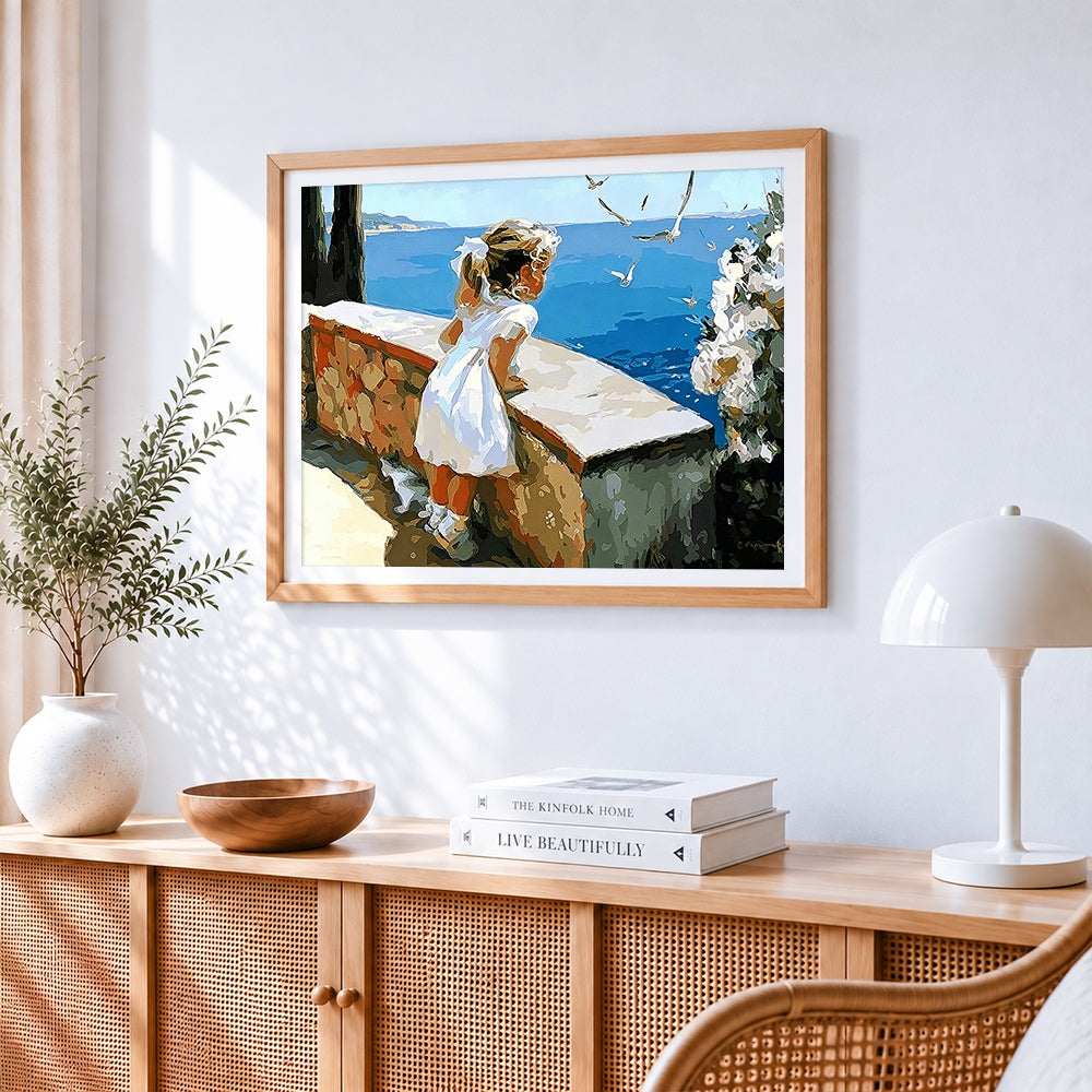 Girl watching seagulls by the sea paint by numbers artwork displayed on wall as home decor
