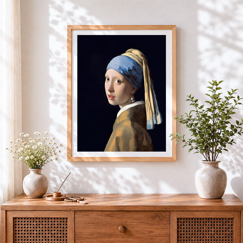 Finished girl with a pearl earring cross stitch artwork displayed