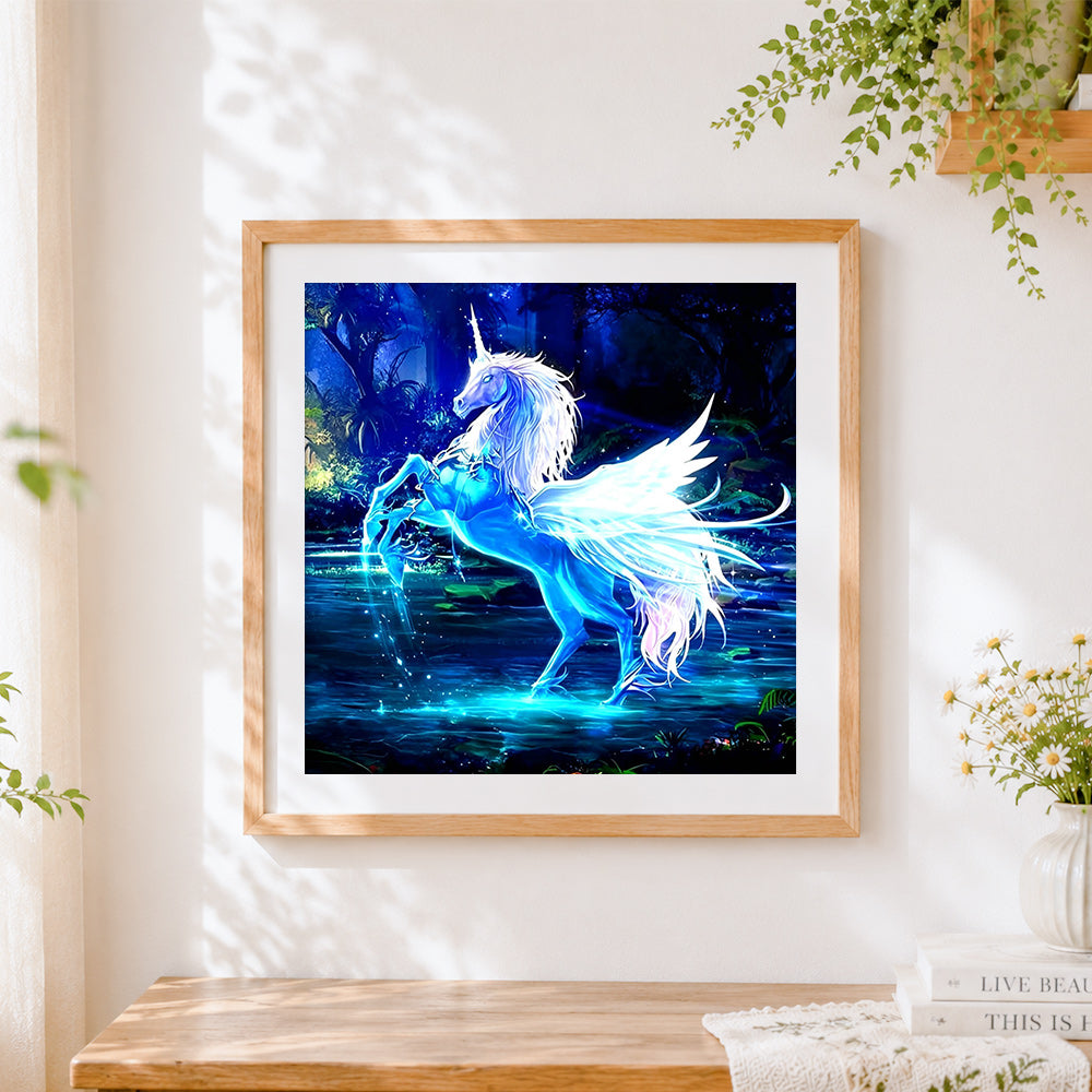Finished glowing blue unicorn in a magical forest cross stitch artwork displayed