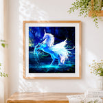 Finished glowing blue unicorn in a magical forest cross stitch artwork displayed