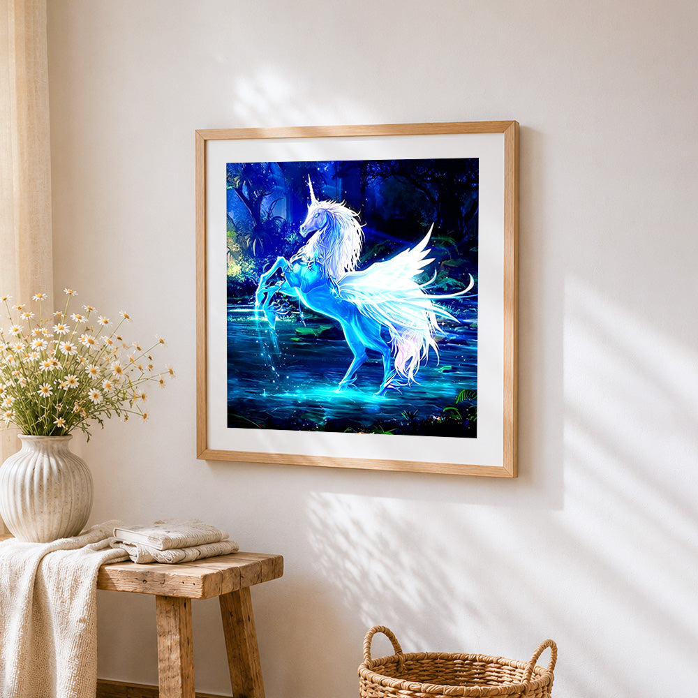Glowing blue unicorn in a magical forest cross stitch artwork displayed on wall as home decor