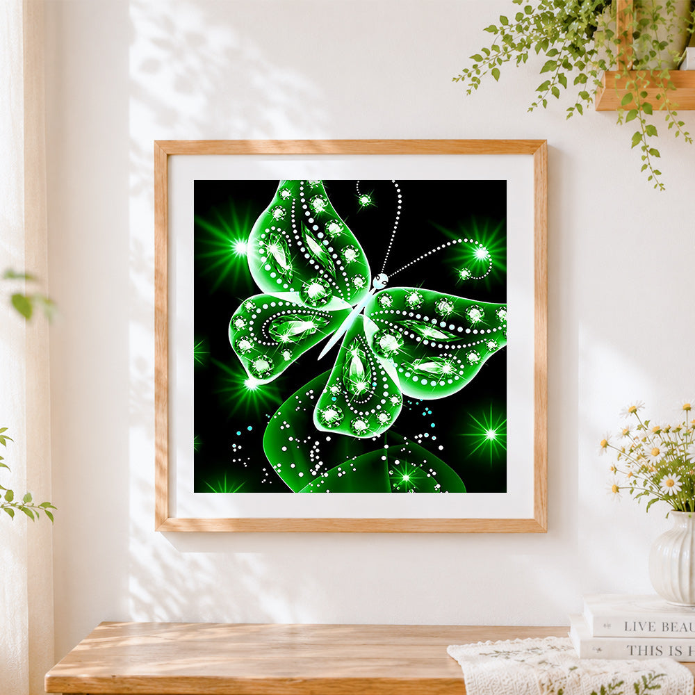Finished glowing green crystal butterfly cross stitch artwork displayed