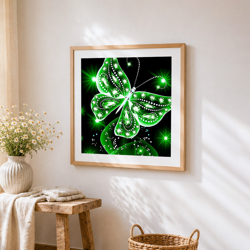 Glowing green crystal butterfly cross stitch artwork displayed on wall as home decor
