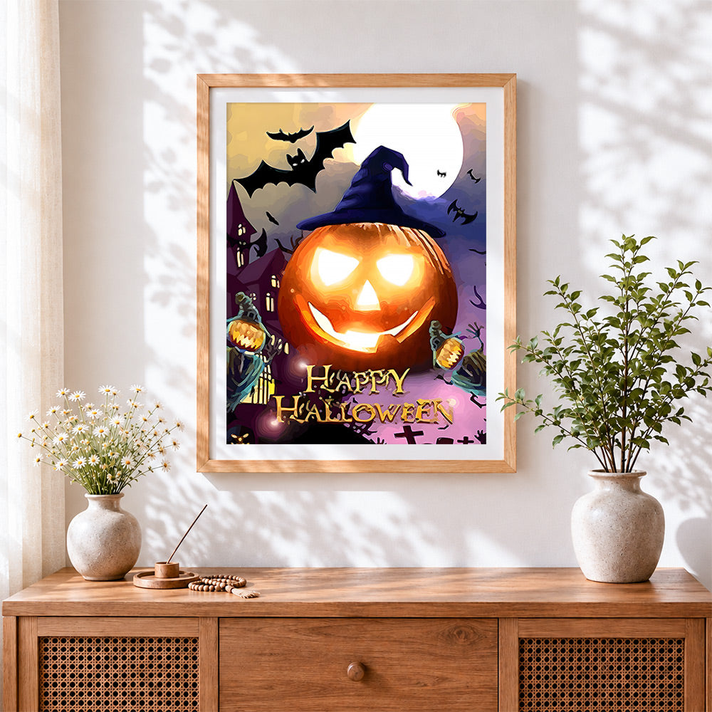 Finished lowing jack-o'-lantern and bats cross stitch artwork displayed